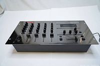 Top view of Vestax PMC-15 MK II 4-channel mixer showing faders, knobs, and mirrored finish.