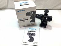 Photo shows box featuring Safari Pro Connect branding, webcam device with USB cable attached, and instruction manual.