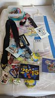 Overview of Disney Cast Member exclusive pins, watch, badges, buttons, lanyard, and souvenirs laid out on a table