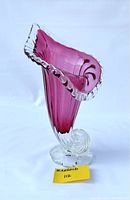 Photo of the cranberry-colored Chalet art glass vase with ruffled clear edge and spiral base, showcasing front and side views.