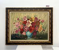 Full view of the framed floral oil painting showing the colorful bouquet in a blue vase with the ornate gold frame.