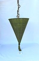 Full side view of the green beaded conical lamp hanging