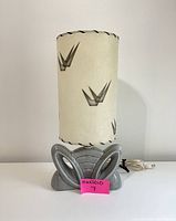 Front view of vintage TV lamp showing ceramic base, fiberglass shade with mid-century abstract design, and power cord.