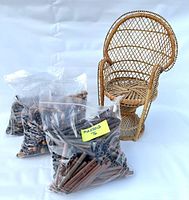 Photo of three clear plastic bags containing assorted loose wooden beads of various shapes and sizes in shades of brown.