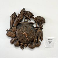 Full view of the vintage Syroco vegetable harvest wall clock showing the vegetable motif and clock face detail.