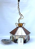 Full view of the vintage Tiffany style hanging lamp showing the metal chain and overall shape with glass panels.
