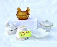 Lot of five vintage kitchen containers displayed: amber glass hen on nest, white ceramic duck dish, studio pottery butter dish, iridescent Avon soap dish, and ribbed glass covered dish with gold rim.