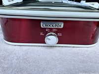 Front view of the red Crock-Pot slow cooker with brand logo and temperature control dial.