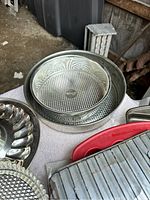Top view showing round glass pie dish placed inside metal round cake pan.