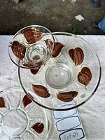 Top-down view of the chip and dip bowl and matching platter showing detailed brown leaf decorations