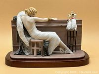 Front side showing the woman reclining with a cat at her feet, two dogs on stools at the bar, detailed hand painting