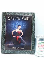 Front cover of the book titled 'An Intimate Portrait Evelyn Hart' showing ballerina Evelyn Hart in black and red costume in a dance pose, with decorative border.