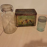 All three items: Lipton tin, clear glass jar with metal hinge lid, and turquoise Crown sealer jar.