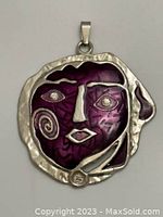 Front view showing purple and silver cubist face design pendant with rhinestone eyes.