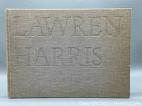 Front cover of the vintage hardcover book with embossed "Lawren Harris" title in fabric cover.