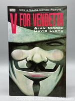 Front cover of the V for Vendetta graphic novel showing Guy Fawkes mask artwork and title with author names.