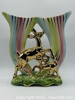 Front view of the ceramic double vase displaying the gold deer figures and pastel colored trumpet vases with gold accents.
