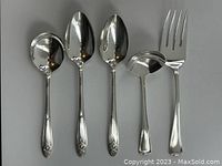 Five-piece silverplated serving cutlery set shown top view on white background, including 3 Wm A. Rogers La Ronnie spoons, one Rogers Bros spoon and one fork
