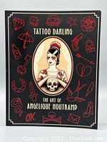 Front cover of Tattoo Darling book showing title, central portrait illustration of tattooed woman, and tattoo-inspired graphic elements