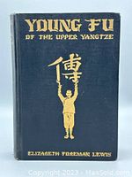 Front cover of the vintage book 'Young Fu of the Upper Yangtze' showing gold embossed title, author name and artwork on dark blue fabric cover.