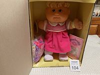 2007 Cabbage Patch Kids doll in original box with visible booklet and accessory pack.