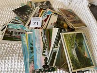 Assorted collection of approximately 120 postcards with visible variety in subject and color.