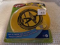 Yellow Pro-Classic Frisbee in sealed original packaging, front view showing branding and weight (130g)