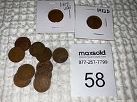 Overview of all 12 Indian Head pennies including the highlighted 1909 VDB and 1912D coins in individual holders.