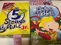 Photo showing 5 Second Rule Jr. and Chutes and Ladders game boxes side by side.
