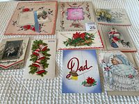 Photo showing the full lot of 9 vintage greeting cards arranged on a white textured surface. Cards depict holiday, baby, floral, and special occasion themes.