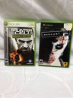 Two Xbox 360 game cases side by side: Splinter Cell Double Agent and Manhunt.