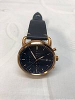 Front view of Fossil FS5404 watch showing blue dial with chronograph functionality and rose gold-tone bezel.