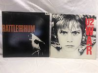 Front covers of two U2 vinyl albums: Rattle and Hum and War