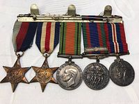 Group shot of all five medals mounted on bar