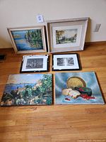 Wide shot of all 6 art pieces on floor showing frames and details