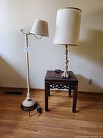 Full view of floor lamp, table lamp on end table against wall