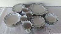 Full set of 8 Winsford China dinnerware pieces arranged on a white cloth, includes plates, bowls, tea cups and saucers