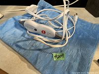 Blue electric heated pad with white control unit and power cord