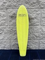 Top view of yellow vintage Huffy Thunder Board skateboard with 1980's branding and a logo printed in black.