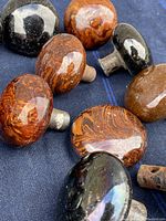 Close-up of polished stone and marble door knobs showing marbling and metal stems