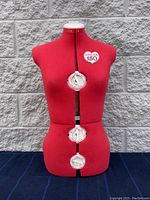 Front view of red Singer 150 adjustable dress form with three size adjustment dials visible in bust, waist, and hip areas.