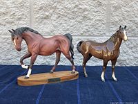 Two brown Beswick horse figurines; one on wooden base, the other standing alone