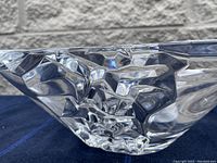 Side angle view of the clear crystal glass bowl showing faceted textured design and polished finish