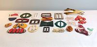 Group shot of 18 Bakelite items including various buckles, brooches, earrings and hair combs