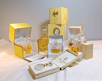 Group shot showing all six boxed perfume bottles, sealed Lalique flacon box, pendant bottle and satin glass bird