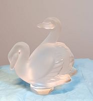 Full view of the Lalique satin glass double swan figurine showing the overall frosted glass and sculptural detail.