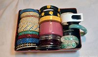 Boxed assortment of narrow rhinestone bangles, wide cuffs, hinged bracelets and Bakelite pieces