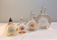 Front view of all four Paris Round flacons showing labels Chamade, Eau de Cologne Guerlain, Shalimar, Chant d’Arômes