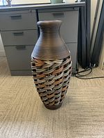 Photo of woven faux vase with wide body and narrow top