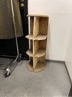 Full view of the wooden cubby storage unit showing hexagonal shape and six compartments.